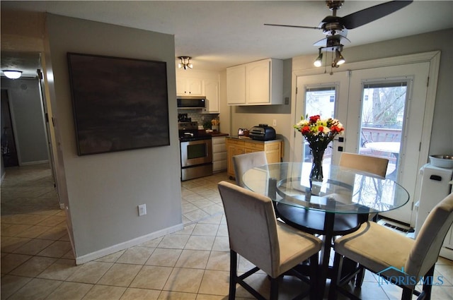 tiled dining room with ceiling fan