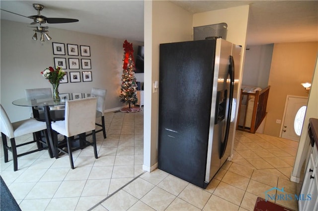 kitchen with white cabinets, stainless steel fridge, ceiling fan, and light tile patterned flooring