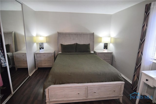 bedroom with dark hardwood / wood-style floors