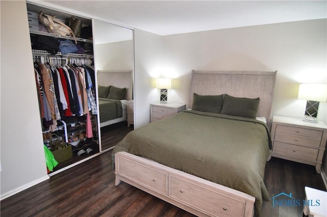 bedroom with dark hardwood / wood-style floors and a closet