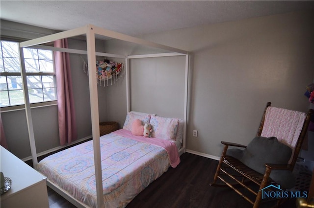 bedroom with dark hardwood / wood-style floors