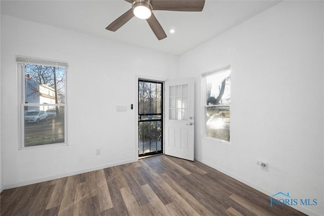 unfurnished room with ceiling fan and dark hardwood / wood-style flooring