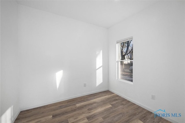 unfurnished room featuring dark hardwood / wood-style floors