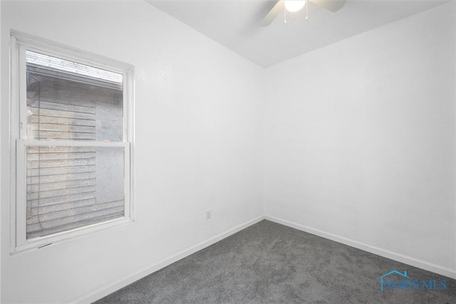 unfurnished room featuring dark carpet and ceiling fan