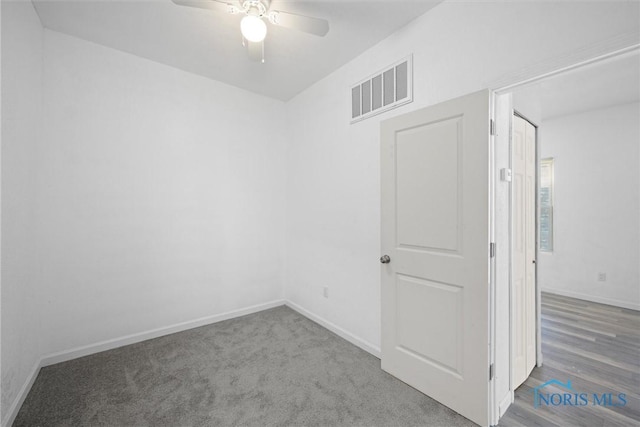 spare room featuring hardwood / wood-style floors and ceiling fan