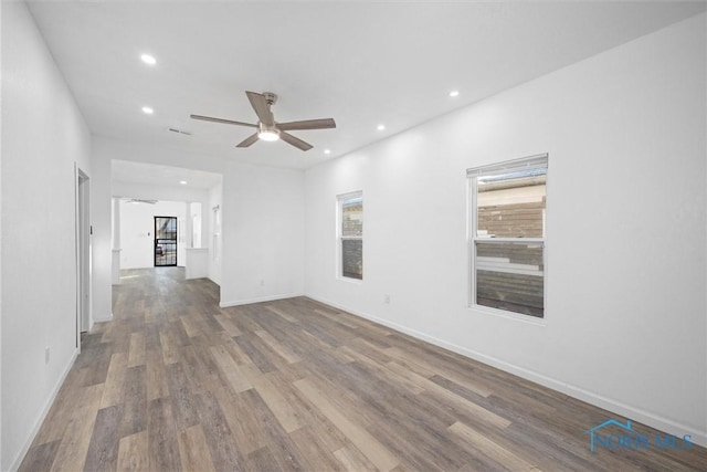 unfurnished room with wood-type flooring and ceiling fan