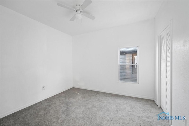 unfurnished room featuring ceiling fan and carpet floors