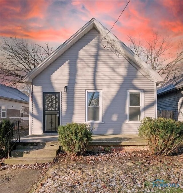 view of back house at dusk