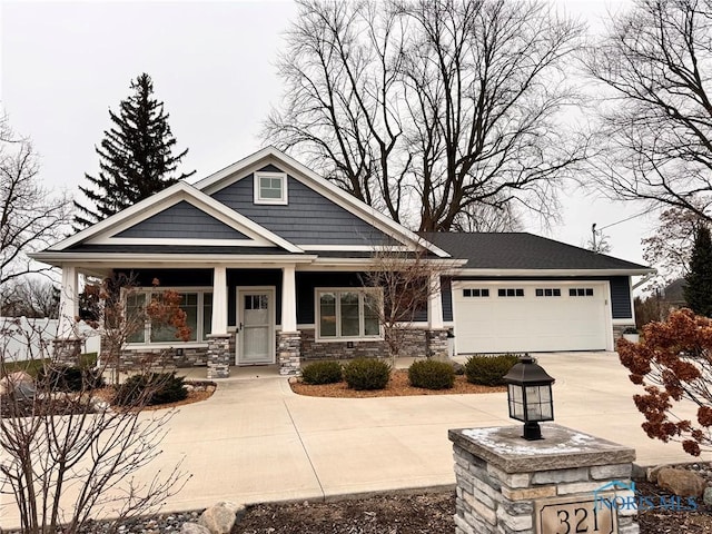 craftsman-style house featuring covered porch and a garage