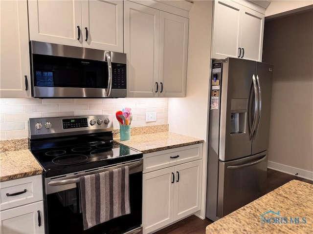 kitchen featuring white cabinetry, light stone countertops, and appliances with stainless steel finishes