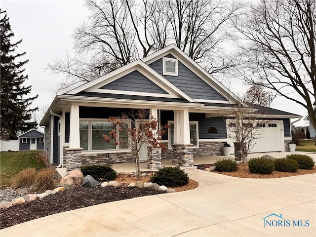 craftsman-style house with a porch and a garage