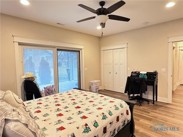 bedroom with a closet, access to exterior, ceiling fan, and hardwood / wood-style floors