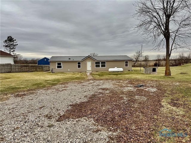 back of property with a lawn