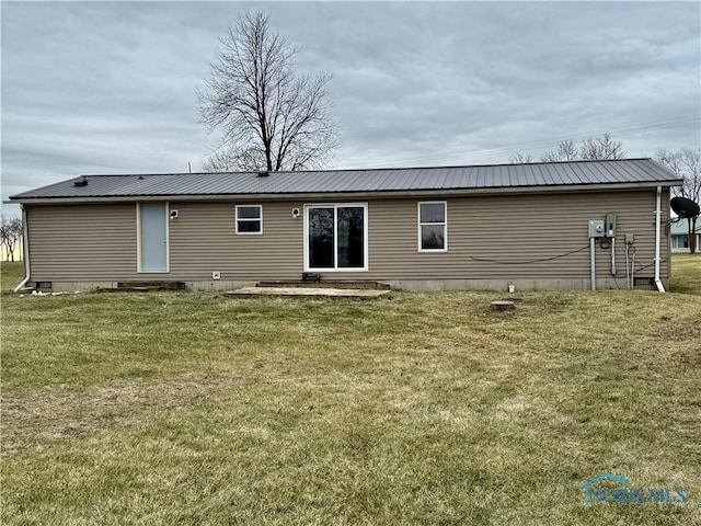 rear view of house featuring a yard