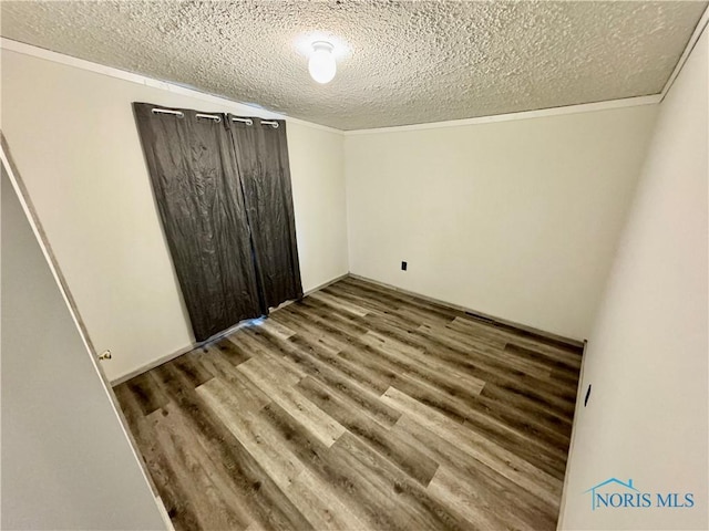 unfurnished bedroom featuring a textured ceiling and hardwood / wood-style flooring