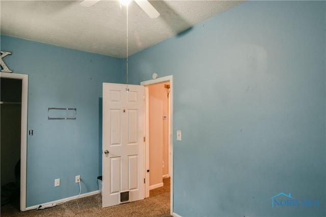 unfurnished bedroom with carpet, ceiling fan, and a textured ceiling