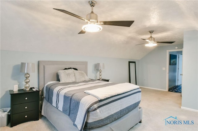 bedroom featuring a textured ceiling, ceiling fan, light colored carpet, and vaulted ceiling