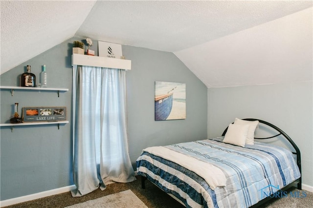 carpeted bedroom featuring a textured ceiling and vaulted ceiling