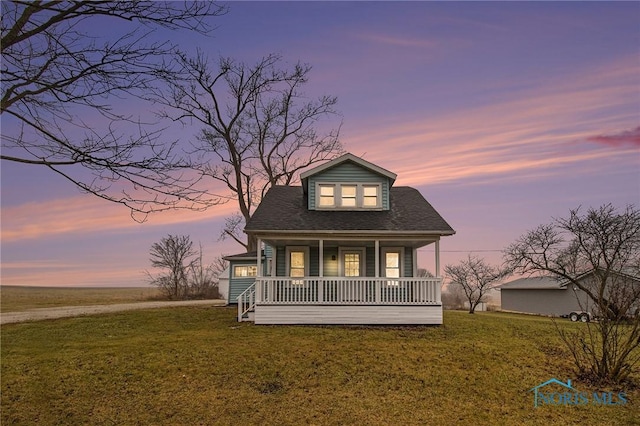 view of front facade featuring a lawn and a porch