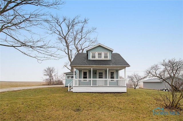 new england style home featuring a porch and a front lawn