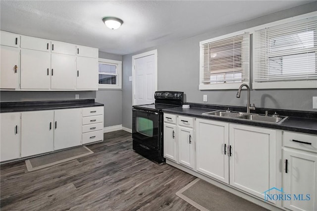 kitchen featuring white cabinets, black electric range oven, sink, and dark wood-type flooring