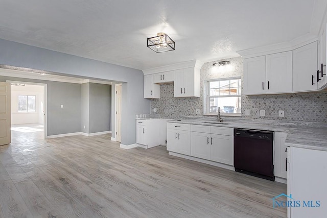 kitchen with decorative backsplash, sink, white cabinetry, and black dishwasher