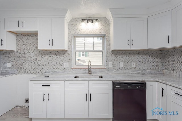 kitchen with backsplash, white cabinets, light stone counters, sink, and dishwasher