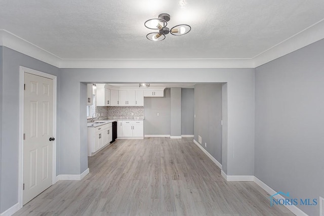 kitchen with decorative backsplash, sink, light hardwood / wood-style flooring, dishwasher, and white cabinets