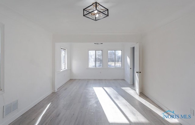 unfurnished room with light wood-type flooring