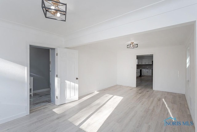 empty room with light hardwood / wood-style flooring