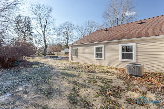 view of side of home with central AC