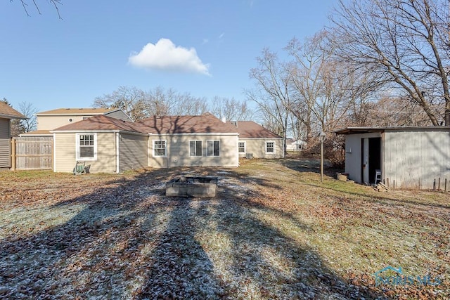 rear view of property with a storage shed