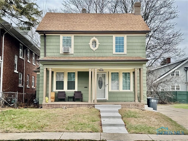 view of front of house featuring covered porch and a front lawn