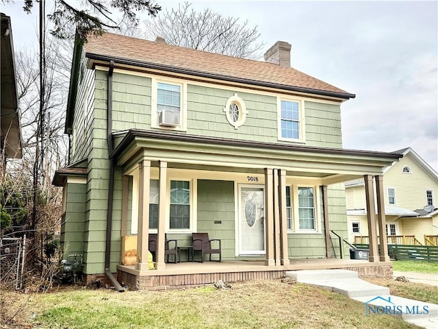 view of front of home with cooling unit and covered porch