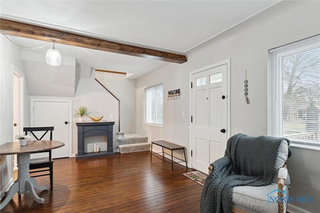 entrance foyer featuring beam ceiling and dark hardwood / wood-style flooring