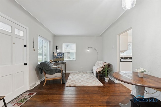 sitting room with dark wood-type flooring