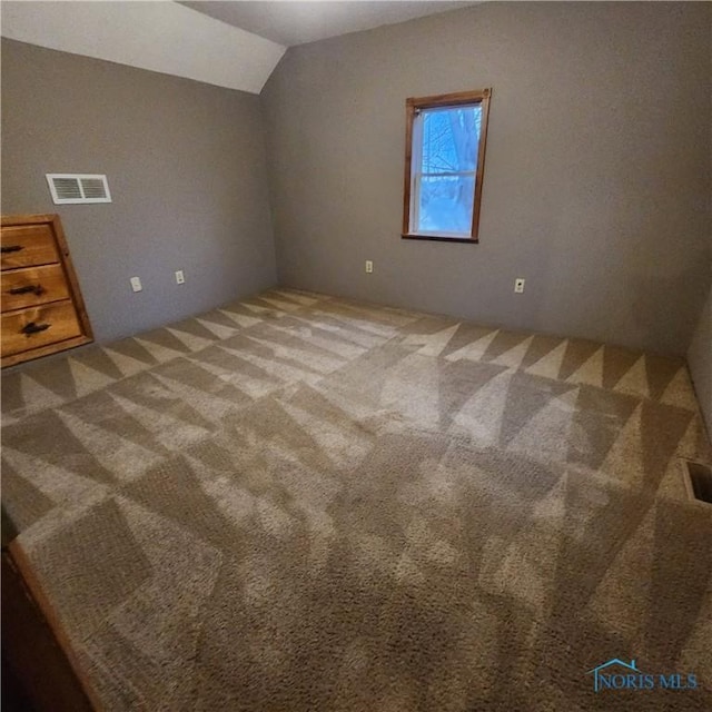 interior space featuring carpet flooring and lofted ceiling