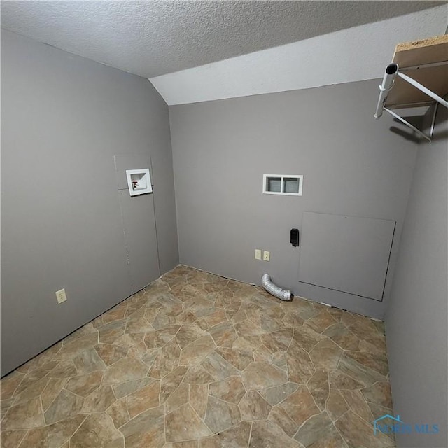 laundry area featuring washer hookup and a textured ceiling