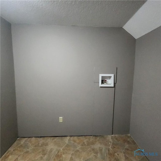 washroom featuring a textured ceiling and hookup for a washing machine