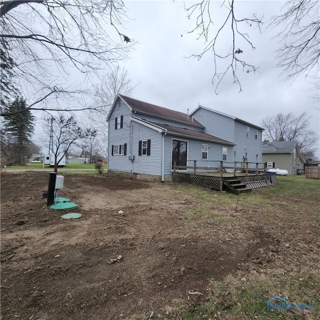 rear view of property featuring a deck