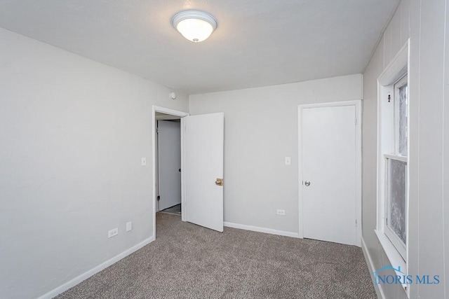 unfurnished bedroom featuring light carpet