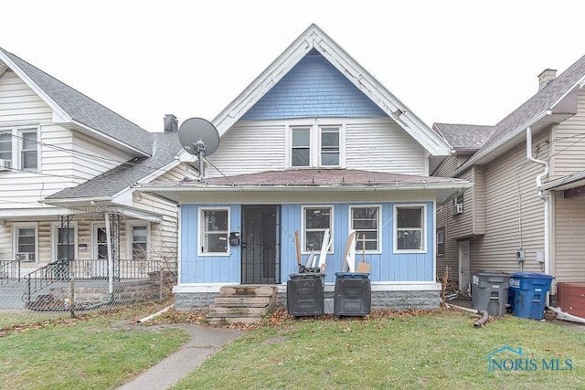 view of front of house with a porch and a front yard