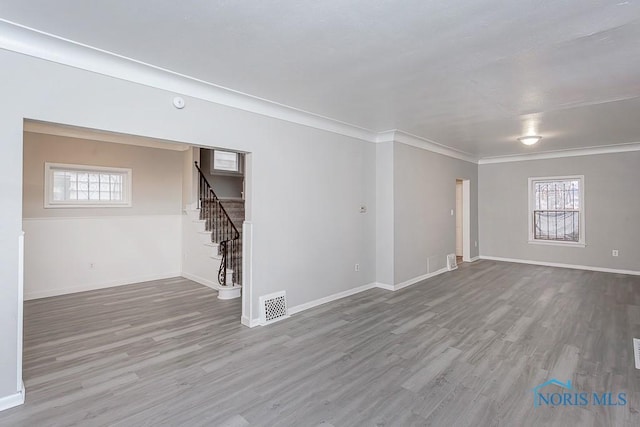 unfurnished room with hardwood / wood-style floors and crown molding