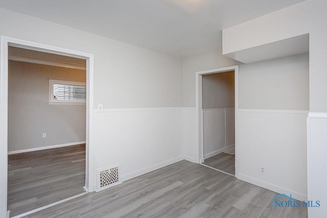 spare room featuring wood-type flooring