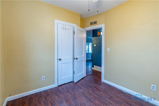 unfurnished bedroom featuring dark wood-type flooring