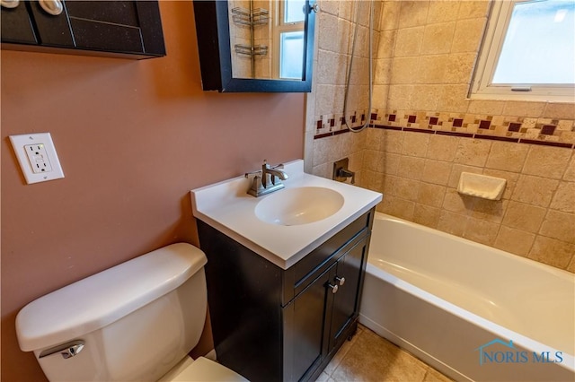 full bathroom featuring tile patterned flooring, vanity, tiled shower / bath combo, and toilet