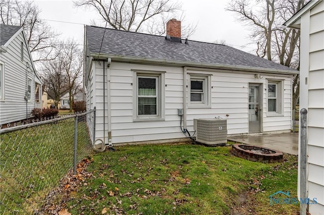 rear view of property with a patio, a lawn, and central air condition unit