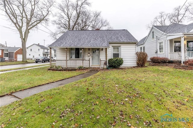 view of front of house with covered porch and a front yard