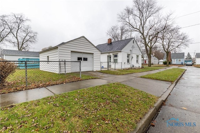 view of front of home with a front lawn and a garage