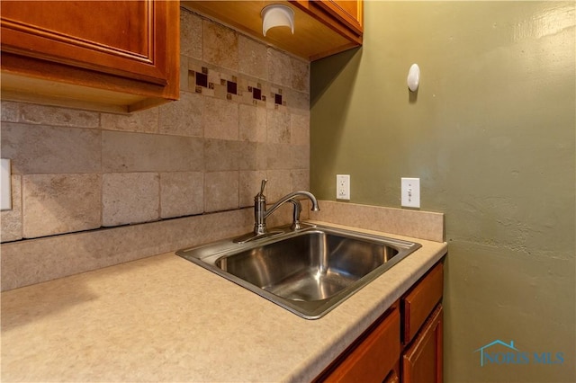 kitchen with tasteful backsplash and sink